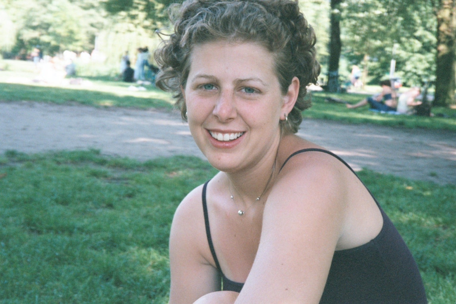 Julie just smiling in Vondel Park in Amsterdam