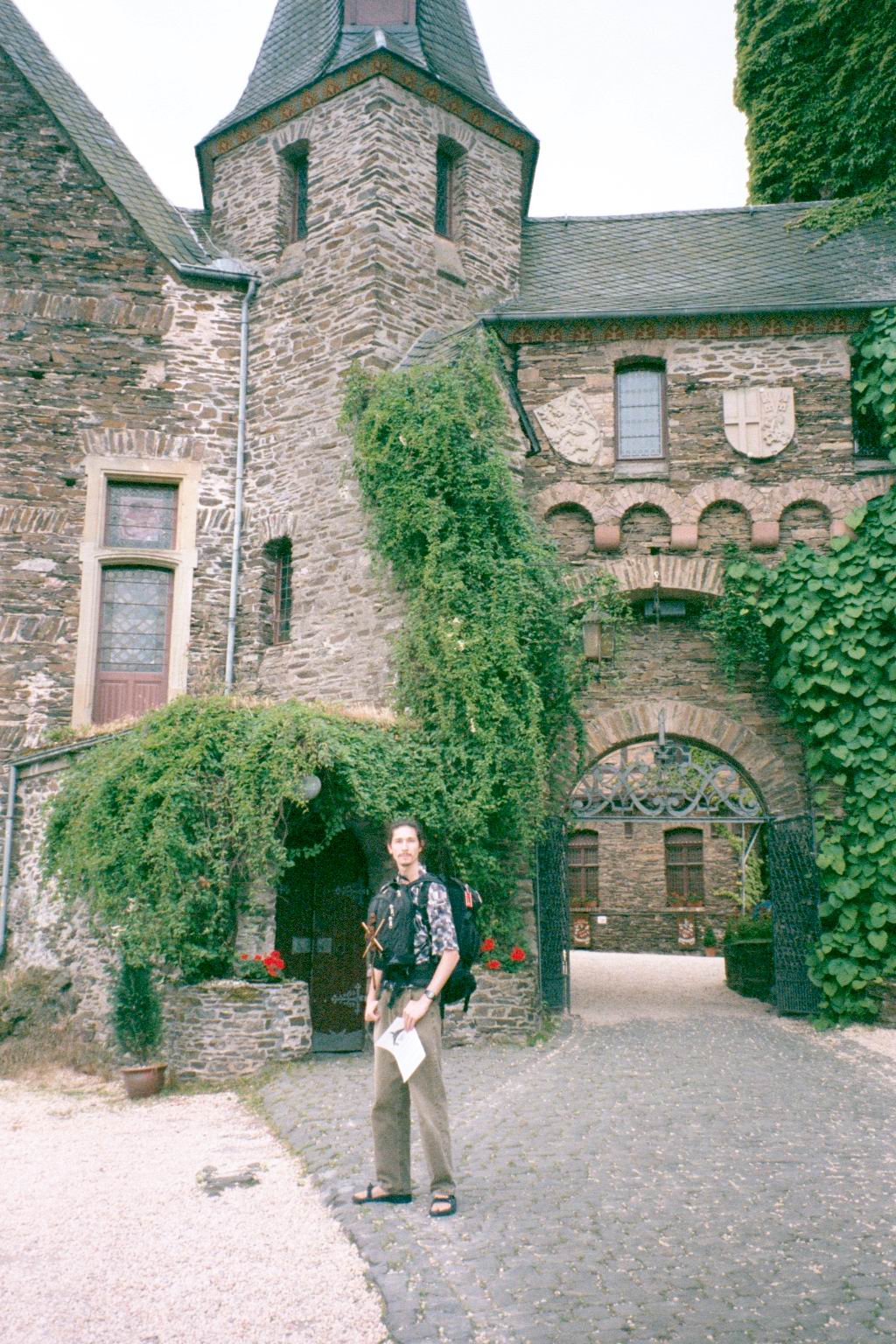 Vince in travel gear at the castle gate