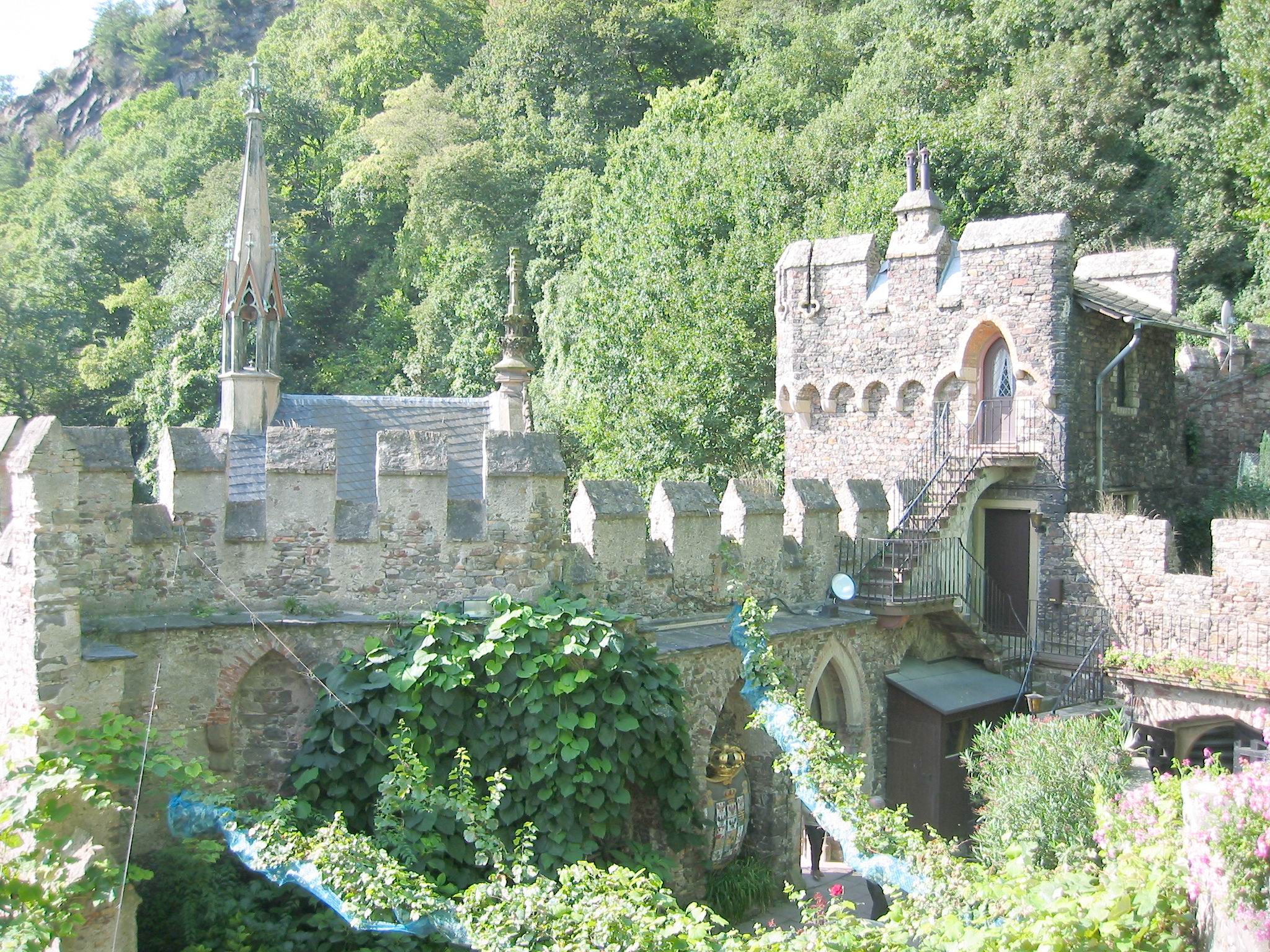 Rheinstein's walled garden is lush, the vineyards are just beyond.