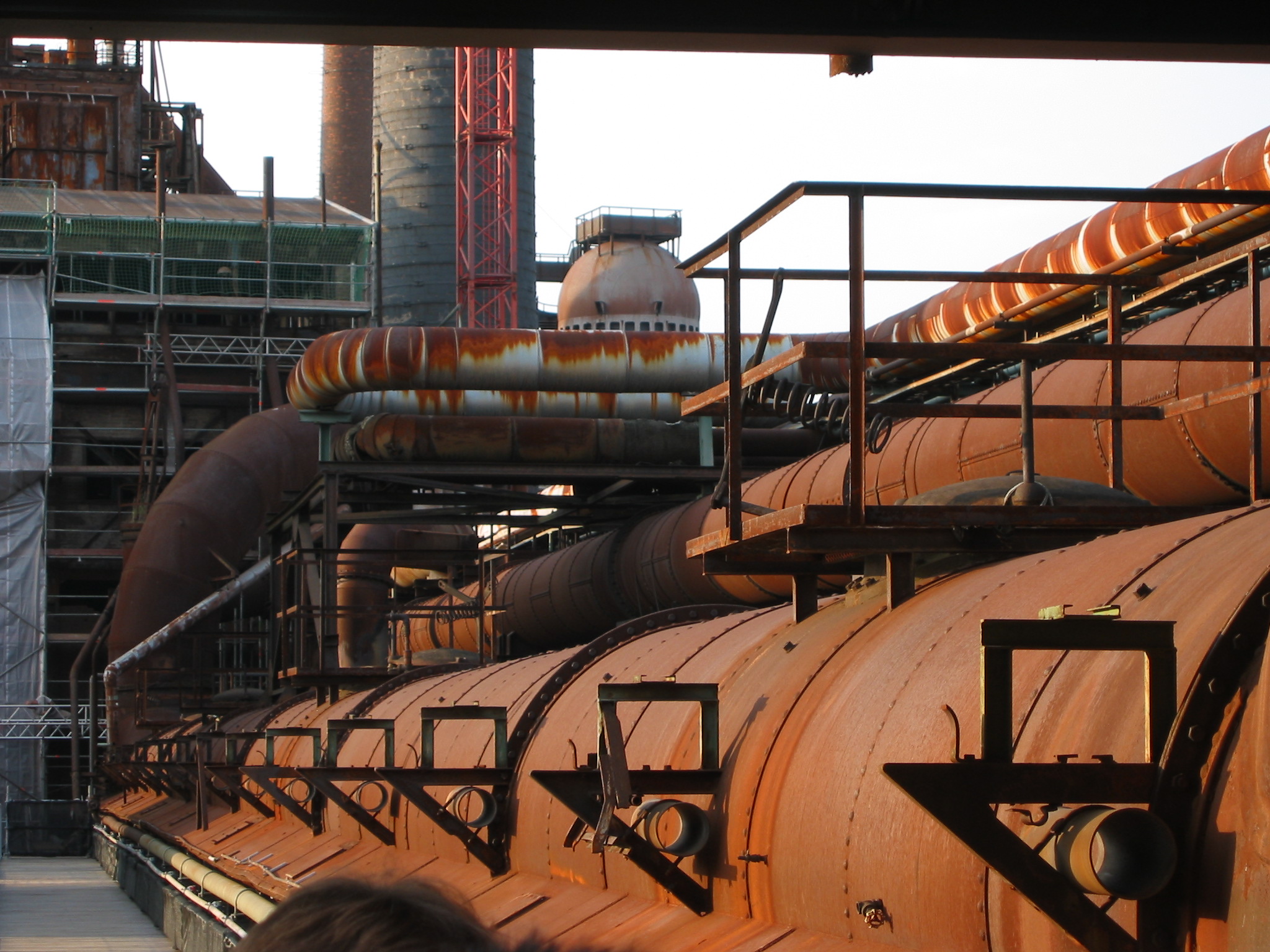 Outside, rust covered pipes, the Vlklingen Ironworks.